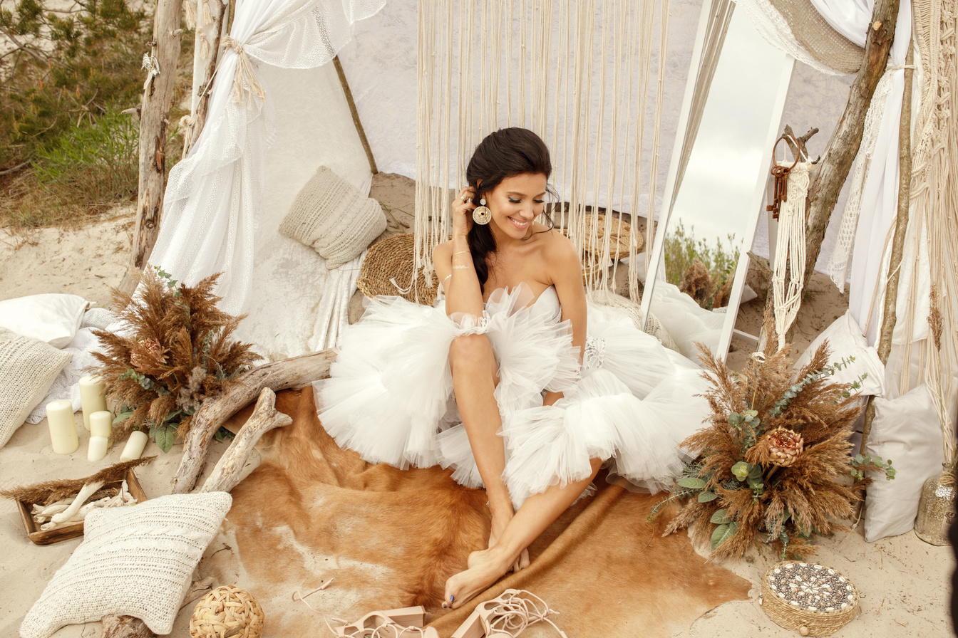 Woman in White Lace Dress in Bohemian Beach Wedding